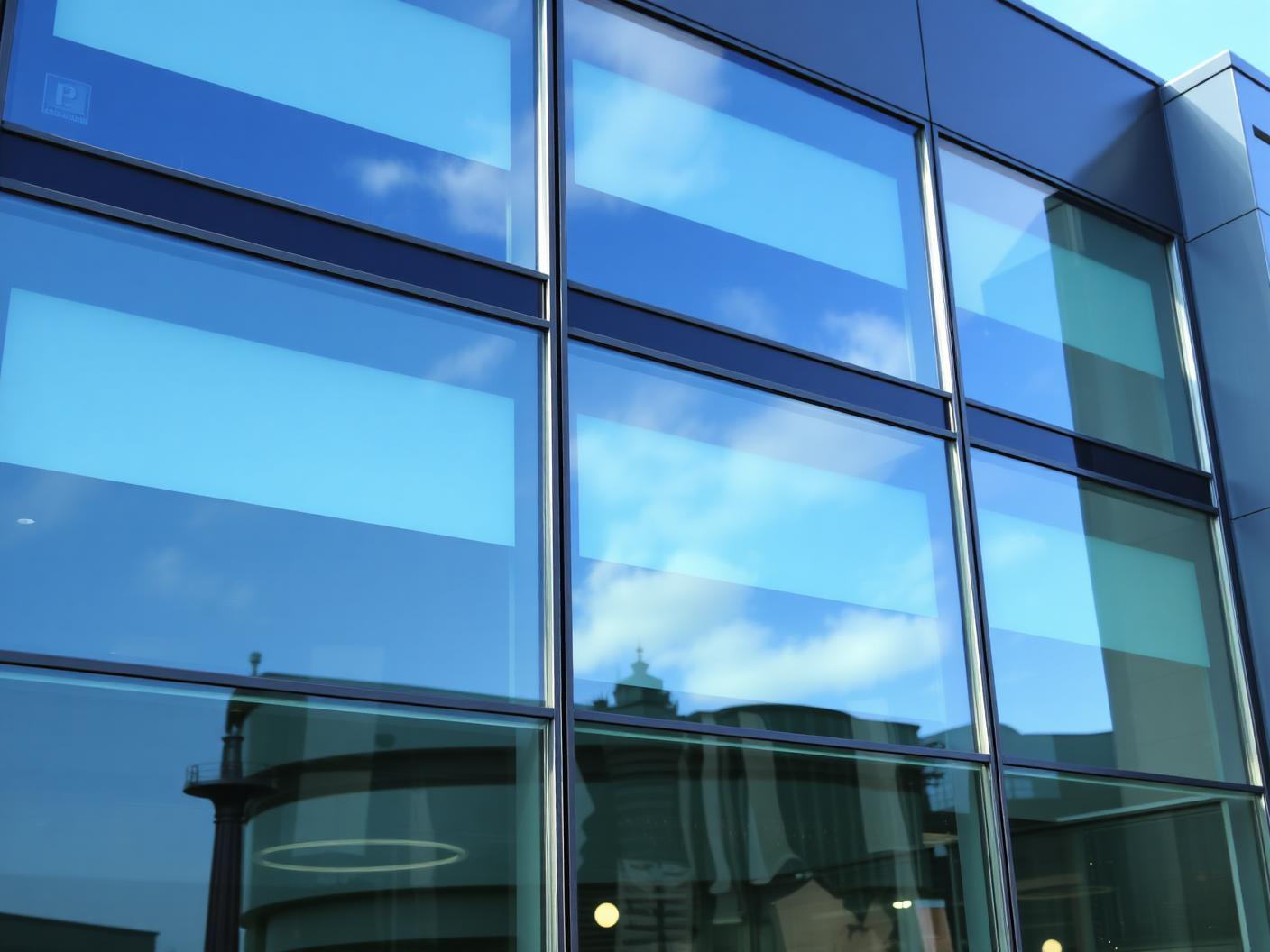 Streak-free glazing on a modern building reflecting the sky